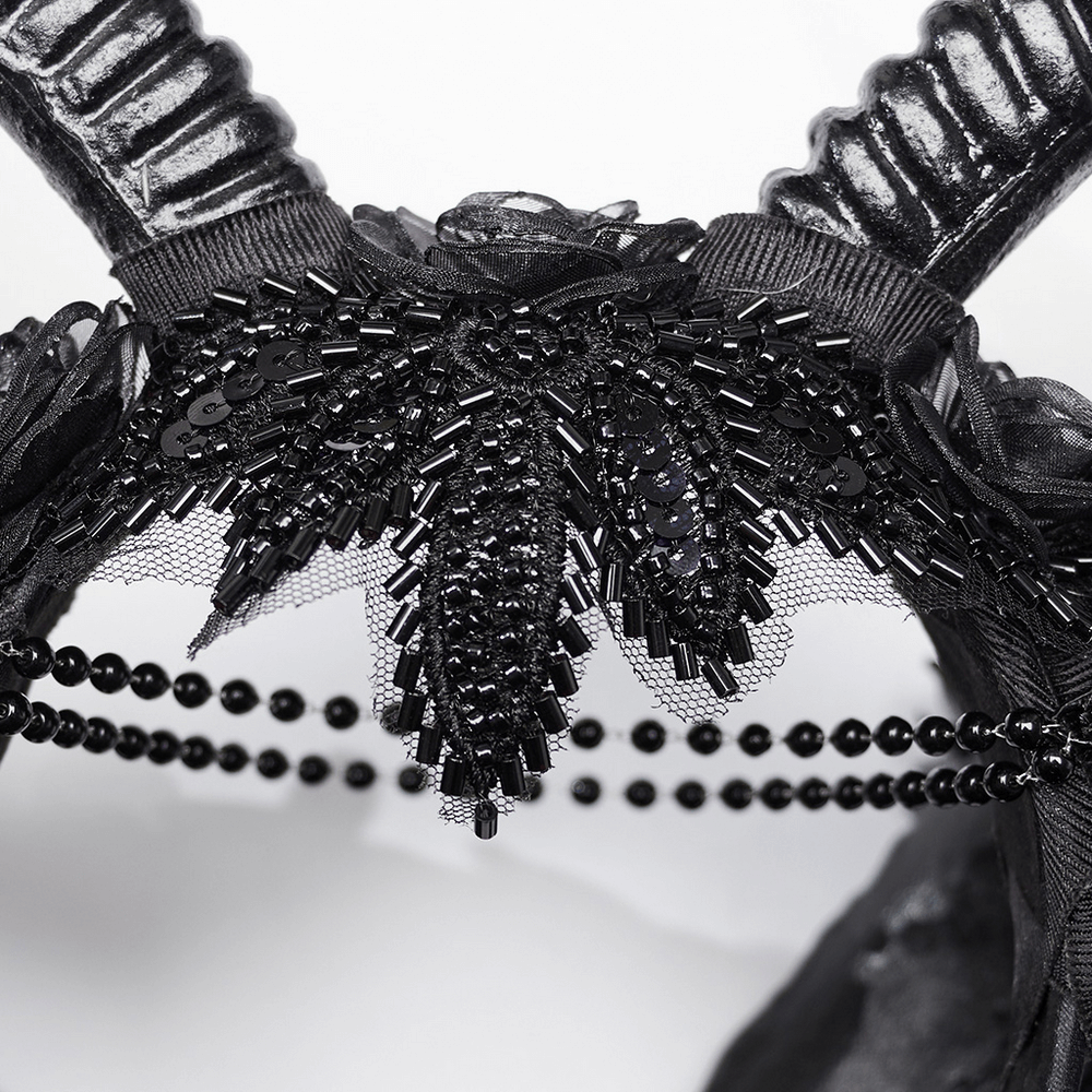 Close-up of gothic horned headpiece with lace and beaded floral detail for a captivating look.