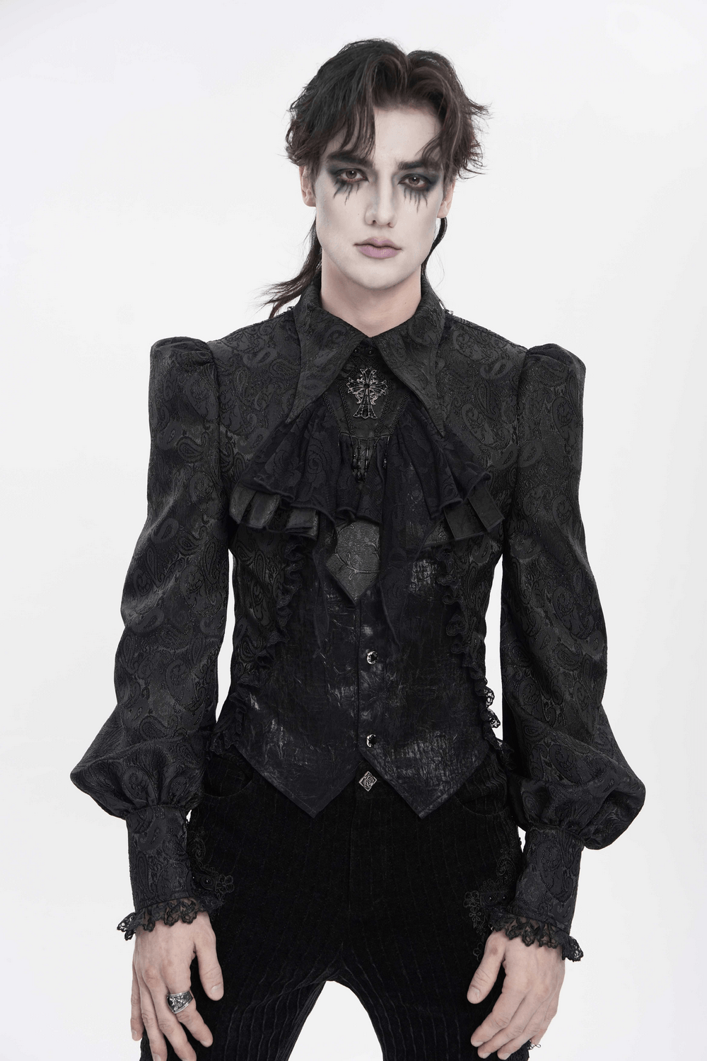 Model in a dramatic black outfit featuring ruffles, perfect for showcasing a Black Gothic Lace Jabot Choker with Cross Pendant.