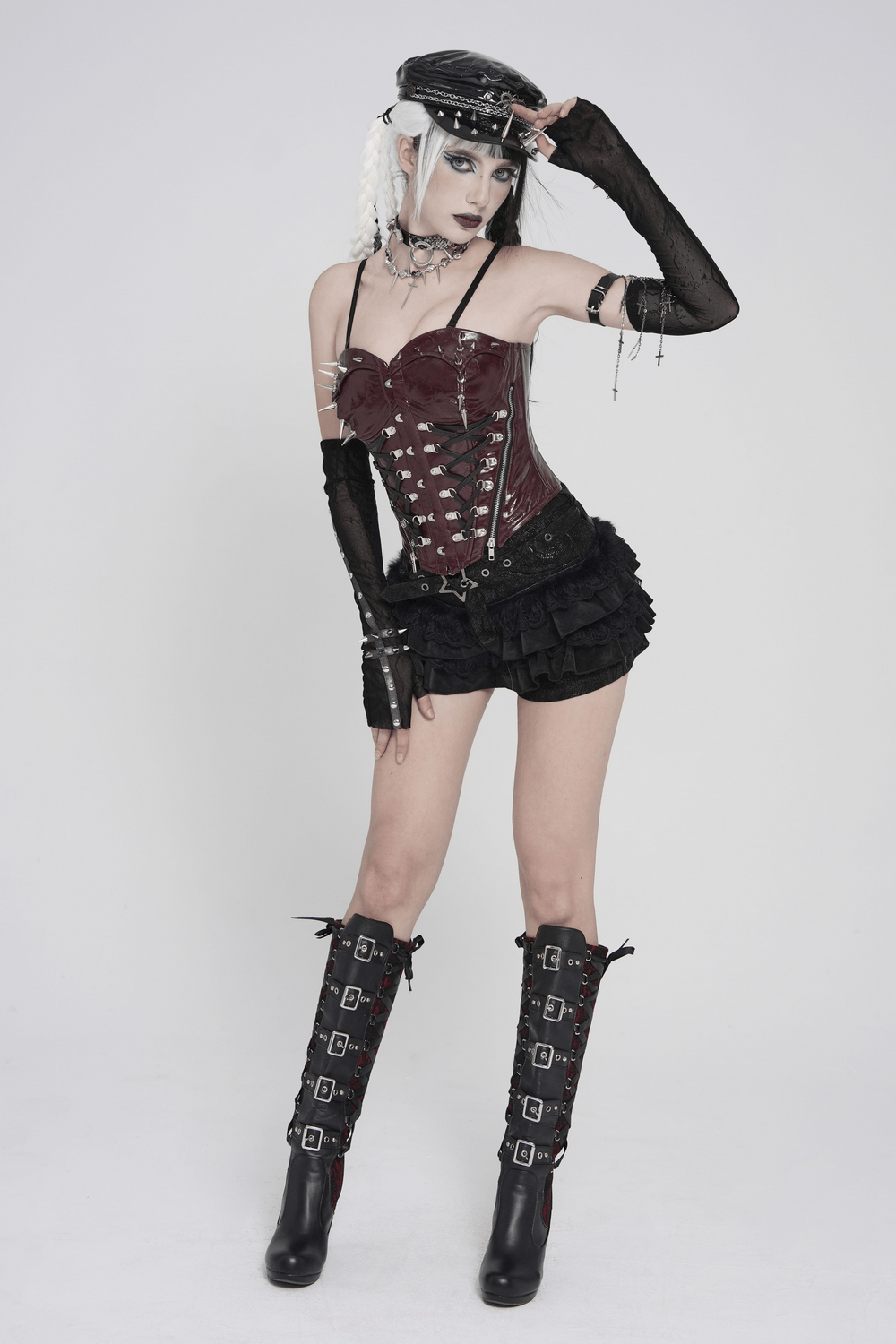 Black Gothic Ruffle Skort with Star Belt Detail paired with edgy accessories and thigh-high boots.