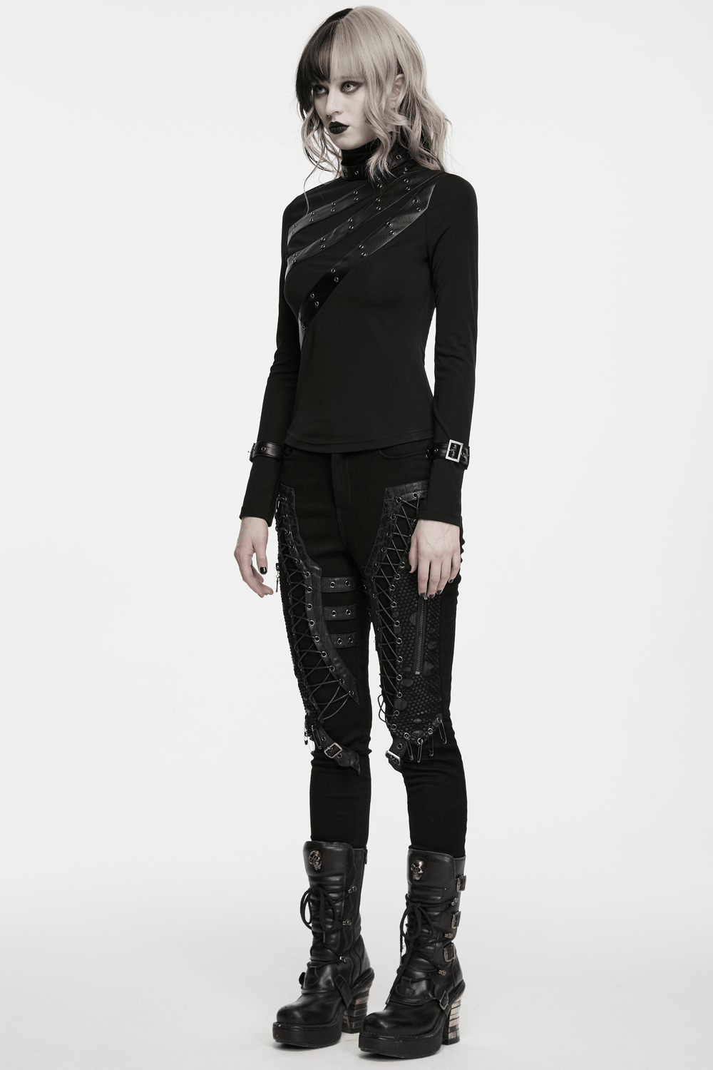 Model showcasing Bold Gothic Lace-Up Skinny Jeans with Buckle Details, paired with a stylish top and edgy boots.