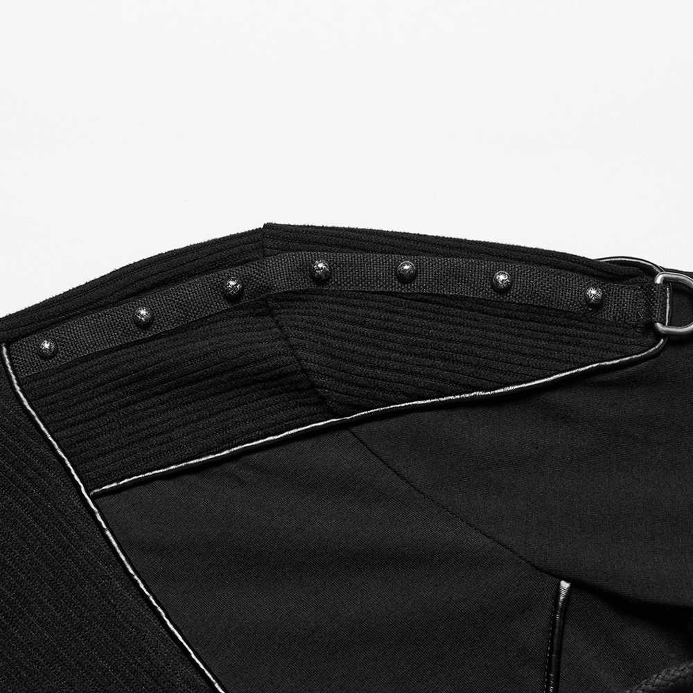 Close-up of black sweatshirt shoulder with rivet straps and contrasting stitching for a cyberpunk look.