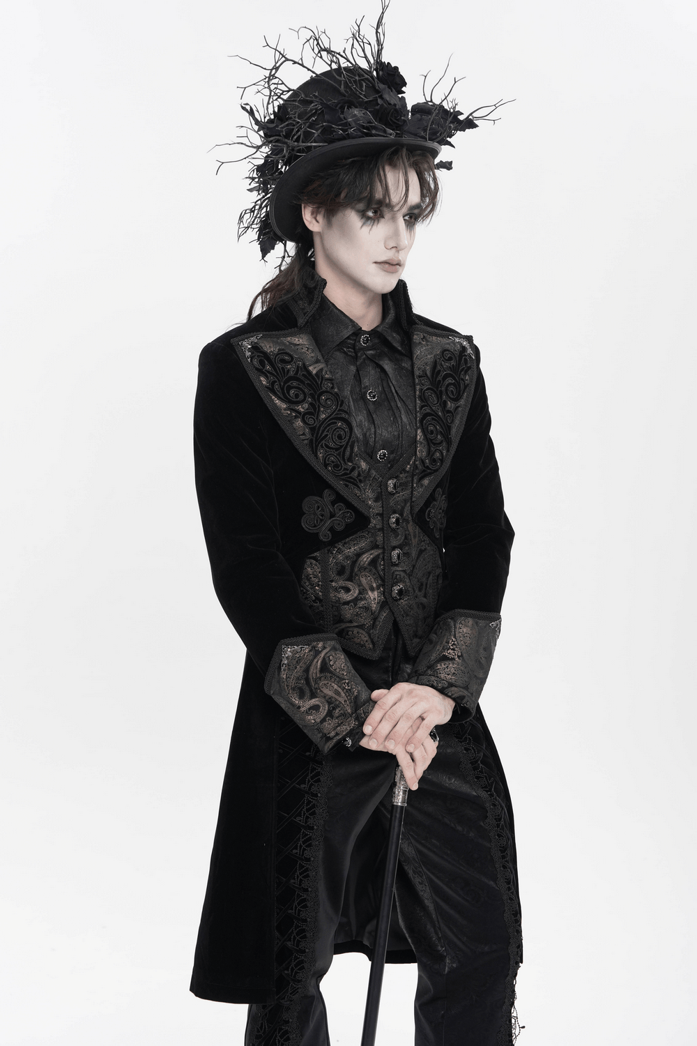 Elegance Black Gothic Tailcoat with Baroque Embroidery worn with a stylish black hat, showcasing ornate details and a theatrical silhouette.