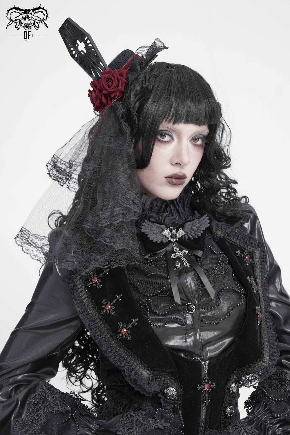 Goth Bat Wing Bow Brooch with Cross Pendant and Ribbon worn by a model in gothic attire with lace and roses.