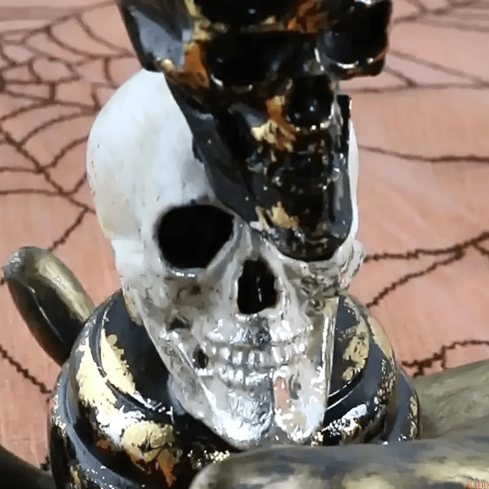 Gothic Double Skull Taper Candle Holder Decor featuring stacked black and white skulls with golden accents.