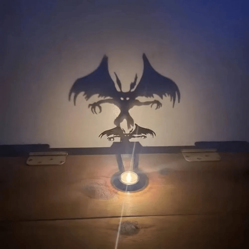 Halloween Shadow Tealight Holder with Metal Scene casting a spooky bat shadow on the wall with tealight lit.