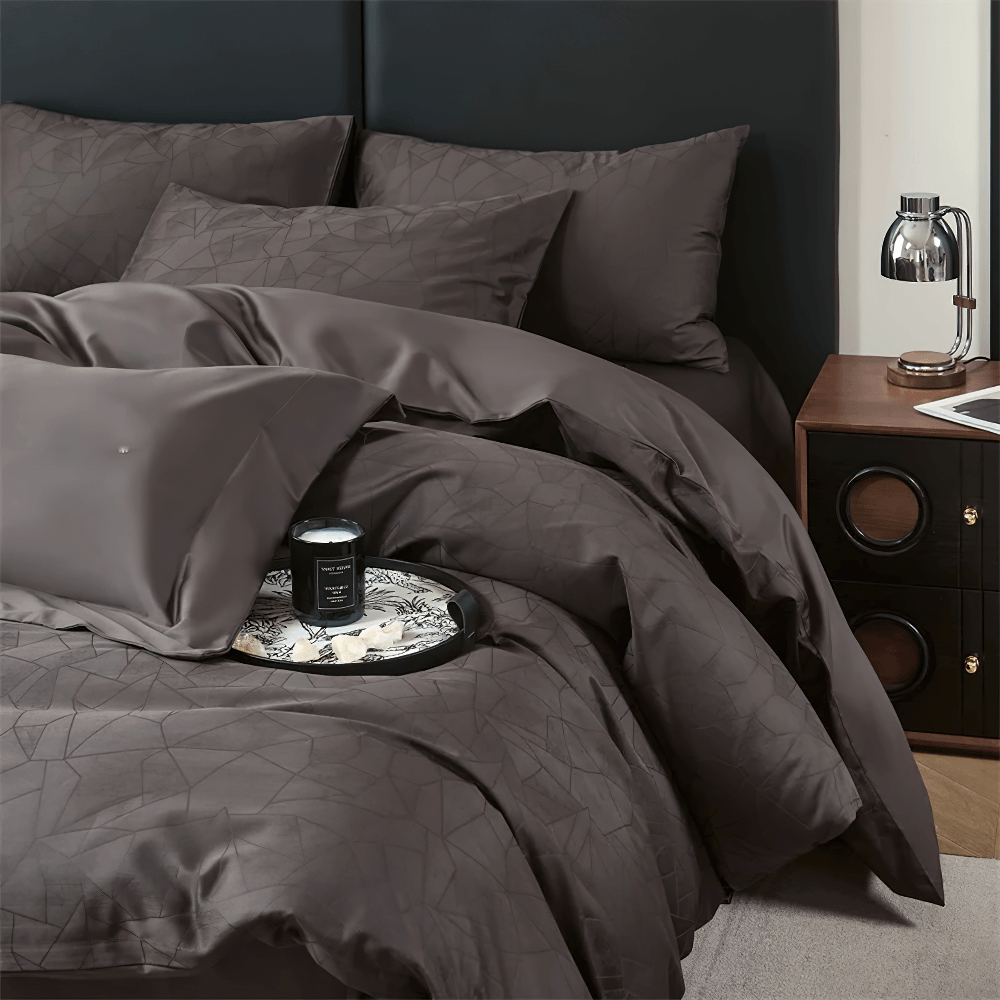 Long Staple Cotton Sateen Jacquard Bedding Set featuring a sleek dark duvet and pillowcases with geometric patterns.