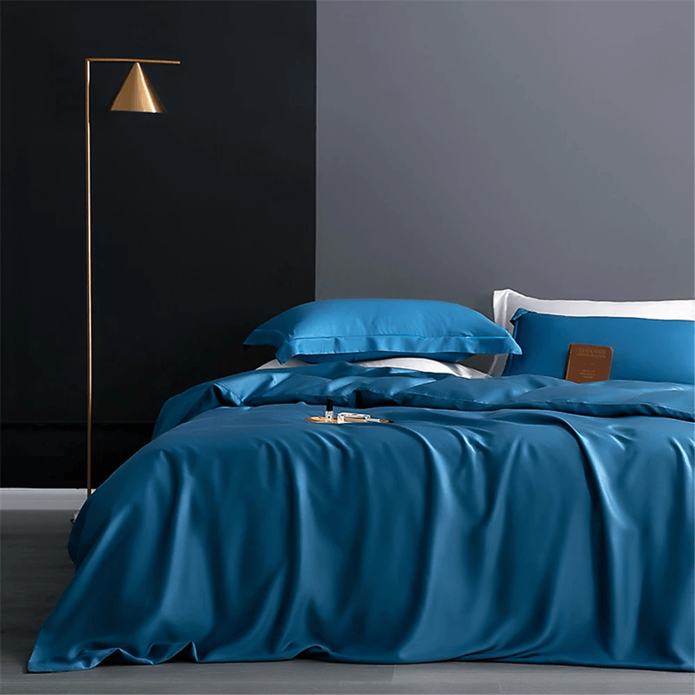 Nature Silk Bedding Set with Duvet Cover and Sheets in elegant blue color on a modern bed.