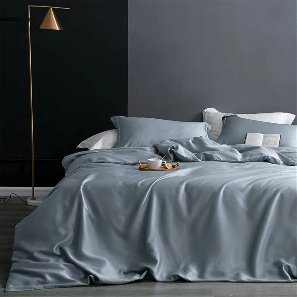 Nature Silk Bedding Set with Duvet Cover and Sheets in elegant gray color, styled with cozy pillows and flat sheet.