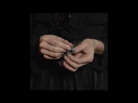 Man hands showcasing the Snake Coiled Consprimus Ring with Intricate Detailing in elegant lighting.