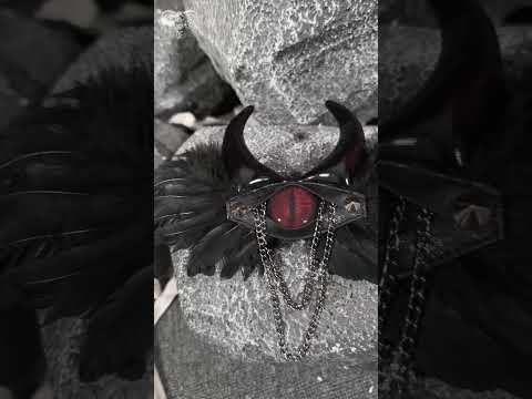 Goth Horn and Feather Brooch with Chain Accents featuring dark feathers, demon horns, and striking red detail.