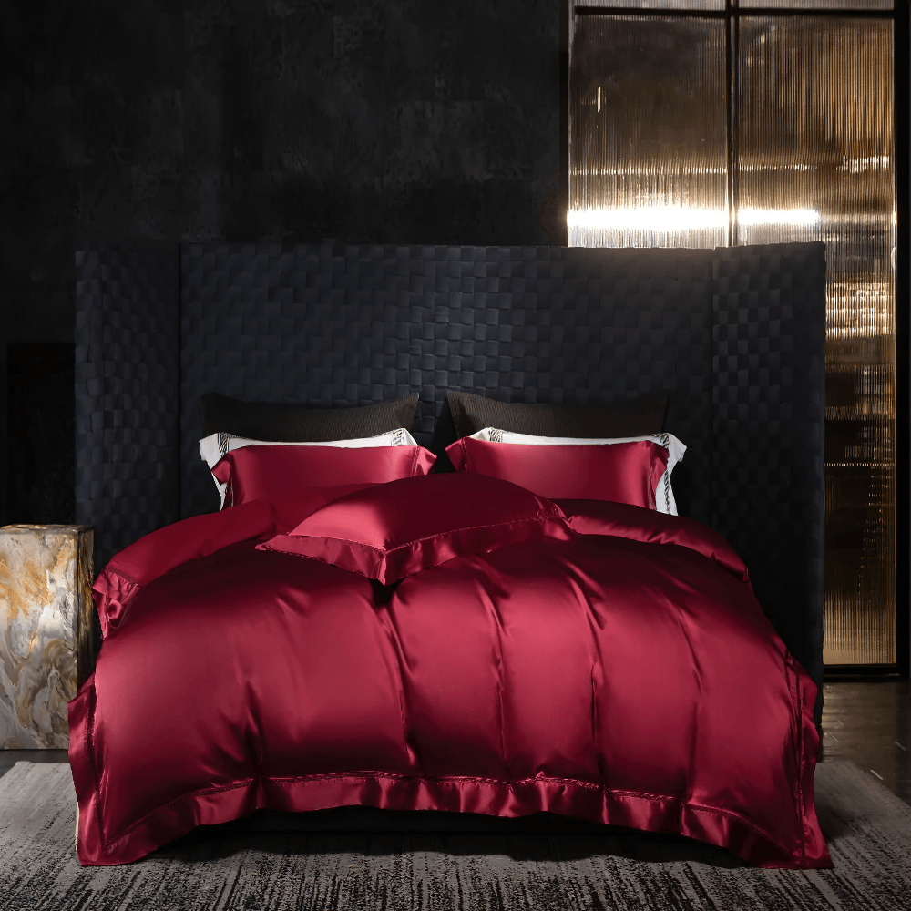 Wrinkle-Resistant Satin Bedding Set With Drape in rich burgundy color against a modern dark backdrop.