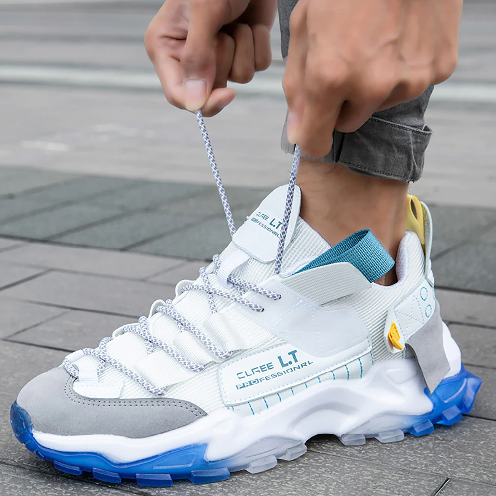 Men tightening laces on stylish breathable sneakers in blue and white, perfect for casual wear and running.