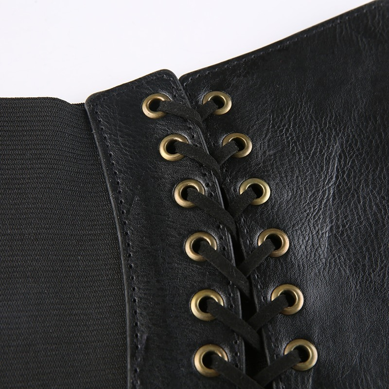 Close-up of vintage women's lace-up PU leather belt showing intricate lace detailing and zipper accents in gothic style.